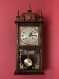 CARVED WOOD PENDULUM WALL CLOCK WITH BRASS FACE