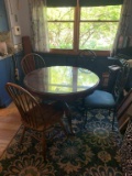 GLASS TOP ROUND WOOD TABLE AND FOUR MISMATCHED CHAIRS