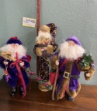 Three Large Santa Figures With Purple Coats