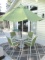 Glass top metal patio table w/4 chairs & umbrella