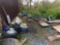 Remaining items behind shop, wheels, water fountain, PVC pipes, concrete pavers, chicken wire, plast