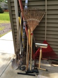 Miscellaneous hand tools,  8 dirt shovels, rakes,  ball hitch and roller stand and levels