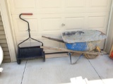 Grass seeder and metal wheelbarrow