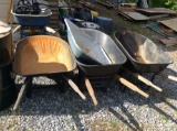 Three wheelbarrows and metal mortar mixing pan