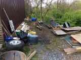 Remaining items behind shop, wheels, water fountain, PVC pipes, concrete pavers, chicken wire, plast