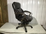 Swivel office chair and brown leather type upholstery