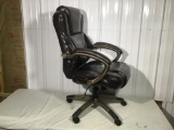 Swivel office chair in brown leather type upholstery