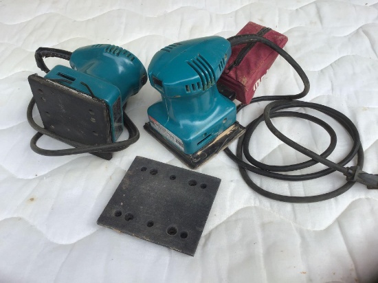 Two Makita palm sanders