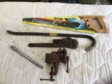Stanley handsaw, wrecking bar, pipe wrench, vice, and half inch extension