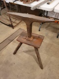 Wooden stand with metal forming iron