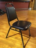 Black, stackable, metal frame chair with cushions