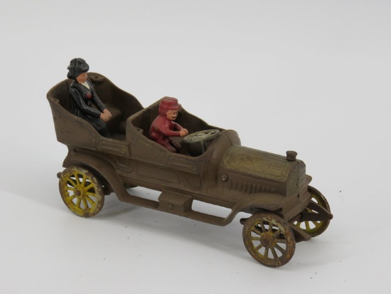 large cast iron open motor car with two figures