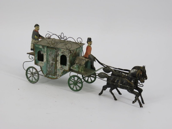 Early tin 2 horse carriage with 2 figures c. 1900