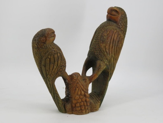 Carved pair of parrots on tree
