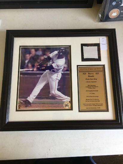 Barry Bonds autographed photo with piece of game used jersey. All framed and matted