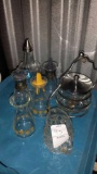 (5) Small glass bottles, some with lids ((1) Creamer (1) Glass Sweet N Low Dispenser