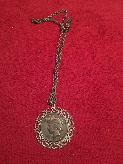 1923 Silver Dollar in ornate pendant with chain. Coin is tarnished or colored
