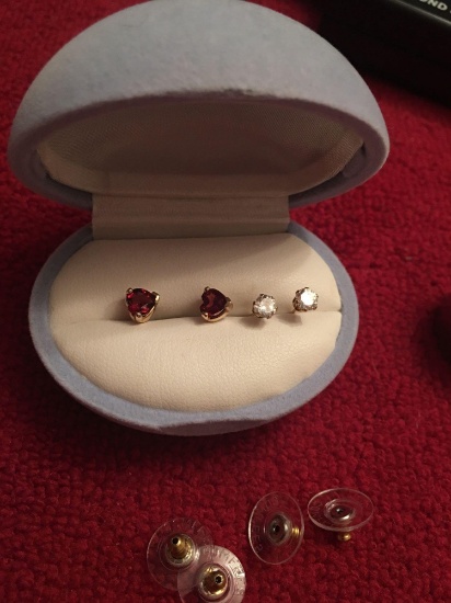 Two pairs 14k gold stud earrings. One clear, one red hearts