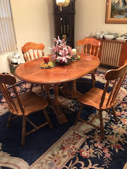 Solid wooden dining table with matching chairs.