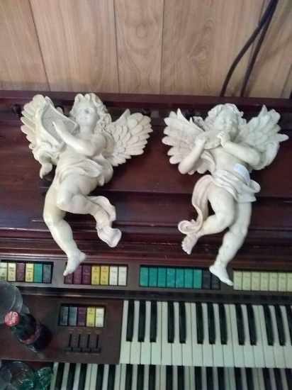 Two hanging angels musical type instruments in hands