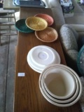 Lot of various sizes mixing bowls and wicker style plate holders