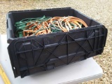Tote full of extension cords, outdoor plug units, and auger, bulbs and more