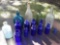 beautiful old bottles including cobalt blue, greens and clear