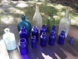 beautiful old bottles including cobalt blue, greens and clear