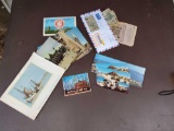 Vintage collection of souvenir postcards and foreign money and money including Daytona, Berlin ,