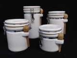 (4) White Ceramic Graduated Canisters with Wooden Spoons