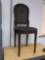 Antique black painted caned seat and back dining chair with carved flower accents