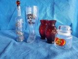 Glass grouping including red vases, Jelly Belly, Dinkle Acker German beer, dolce
