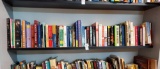 Book shelf grouping including Morley. MacArthur, dictionaries, fiction, Clancy, Christian