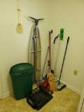 large grouping of cleaning, house care supplies including brooms,trash can