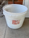 3 large plastic Purina feed buckets.