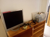 grouping of electronic cords, surge protectors, monitor