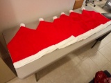 six huge Santa hats, possibly covers for something