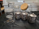 Glass, Stainless, Plexi canister grouping including napkin rings