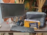 DELL monitor on stand, keyboard, TARGUS messanger bag, cartridge