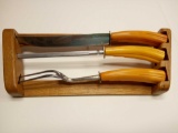 THREE PIECE BUTTERSCOTCH BAKE LIGHT CARVING SET ON WOOD STAND