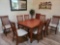Large Cinnamon Wood dining table with leaf and 8 chairs