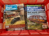 Large collapsible red tote full of Model Railroader magazines