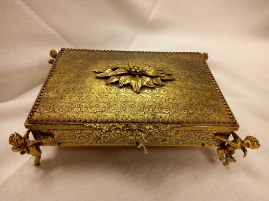 ANTIQUE GOLDEN METAL MIRRORED JEWELRY BOX WITH FLANKING CHERUBS