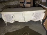 (WILDWOOD PICK UP) -Large cream colored French Provincial solid wood cabinet with wicker insert