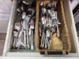 Contents of flatware/silverware drawer including several patterns