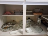 Kitchen shelf grouping including various pot lids, Pyrex Casseroles, pie, bowls