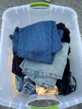 Tote of Unsearched linens including denim pants, shirts, appear to be Men?s