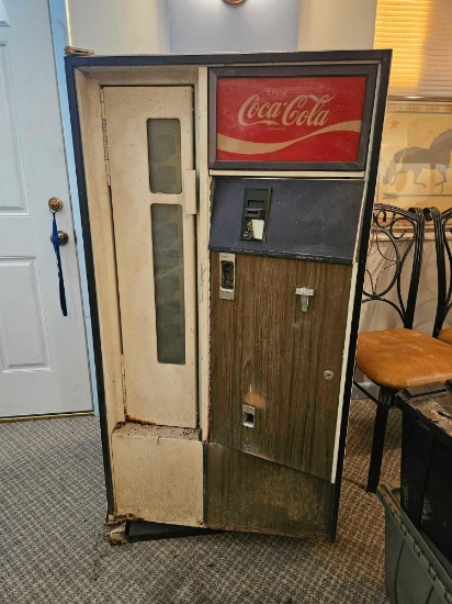 Very vintage Coca-Cola bottle dispensing machine.