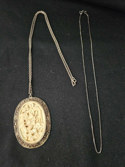 (2) STERLING CHAINS, WITH CARVED PENDANT