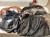 Large grouping of travel bags, including tapestry, duffles, faux alligator.